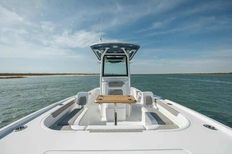 Slide: The Image of 2024 Caymas 281 HB boat on open water, featuring spacious deck and seating. - 22