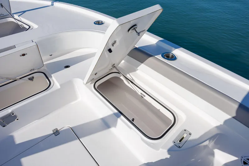 Slide: The Image of 2024 Caymas 281 HB boat deck with open storage compartment, showcasing sleek design and functionality. - 23