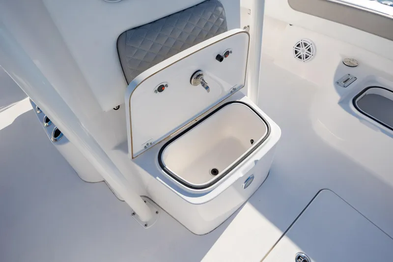 Slide: The Image of 2024 Caymas 281 HB boat interior with open storage compartment and cushioned seating. - 25