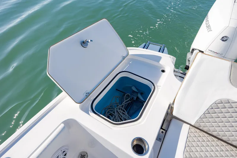 Slide: The Image of Open storage compartment on 2024 Caymas 281 HB boat, showing ropes and anchor. - 29