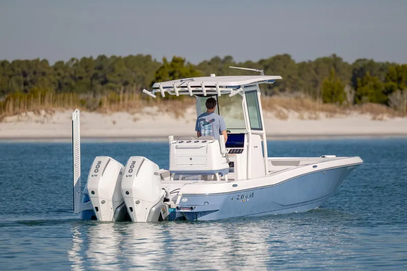 Slide: The Image of 2024 Caymas 281 HB boat with dual engines cruising on calm waters. - 3