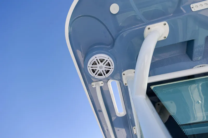 Slide: The Image of 2024 Caymas 281 HB boat detail with speaker and railing against blue sky. - 33