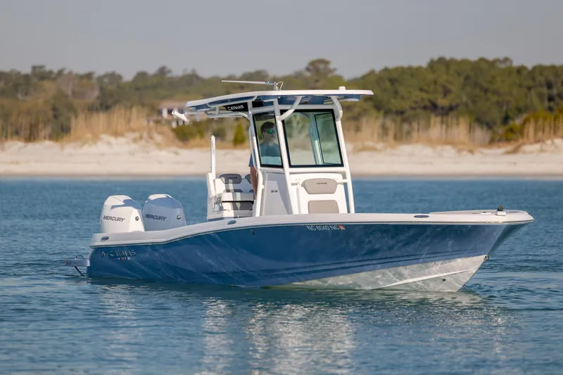 Slide: The Image of 2024 Caymas 281 HB boat on calm water, featuring dual Mercury engines. - 5