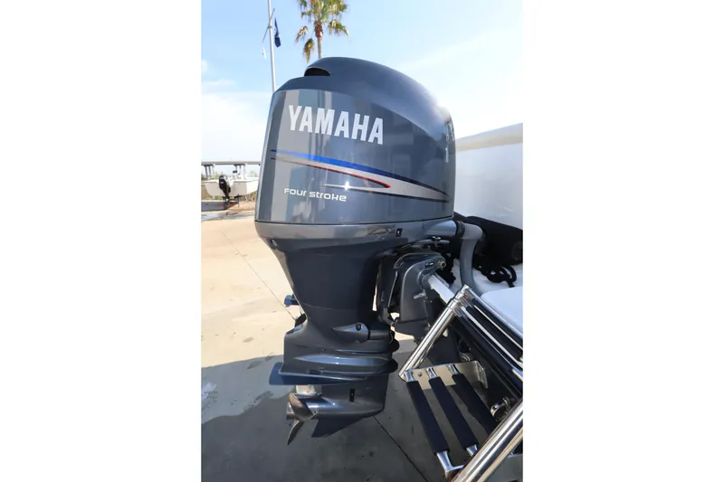 Slide: The Image of Yamaha four-stroke outboard motor on a 2009 Century 2400 Walk-Around boat. - 12