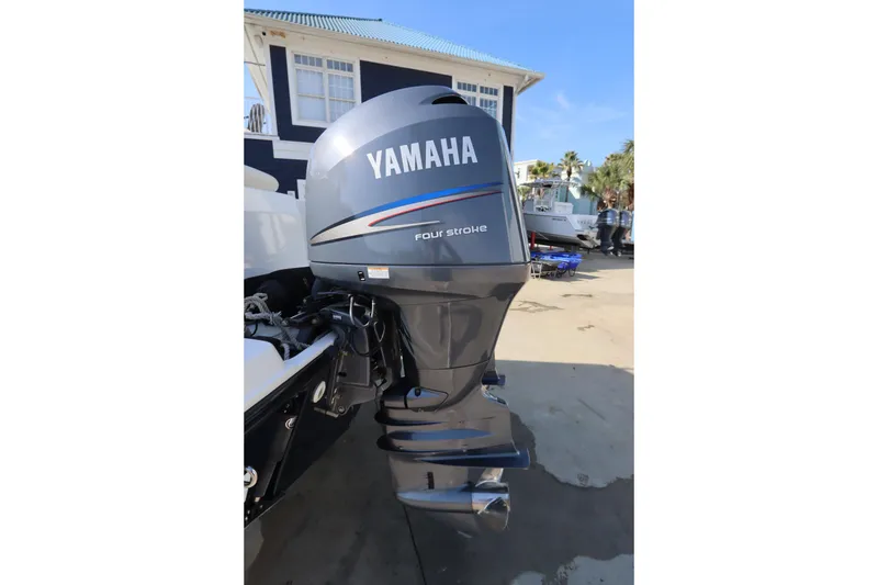 Slide: The Image of Yamaha four-stroke outboard motor on a 2009 Century 2400 Walk-Around boat. - 13