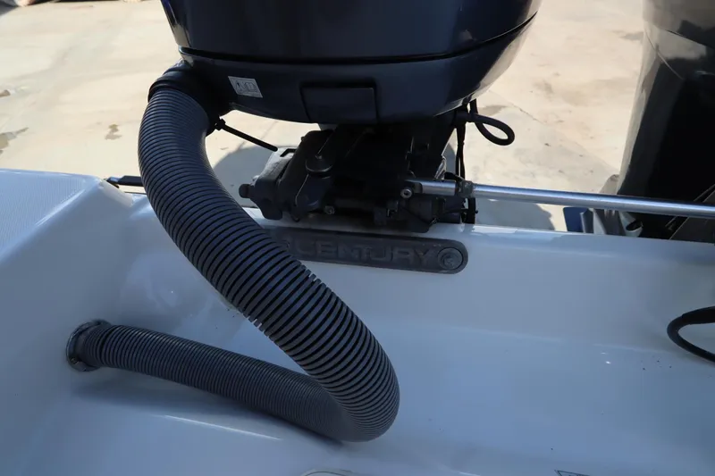 Slide: The Image of 2009 Century 2400 Walk-Around boat engine detail with visible hose and branding. - 17
