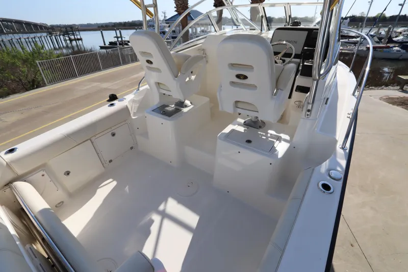 Slide: The Image of 2009 Century 2400 Walk-Around boat interior with helm seats and spacious deck. - 20