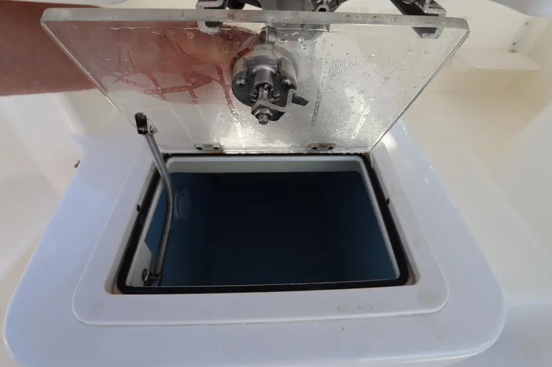 Slide: The Image of Open hatch on 2009 Century 2400 Walk-Around boat, showing interior compartment. - 25