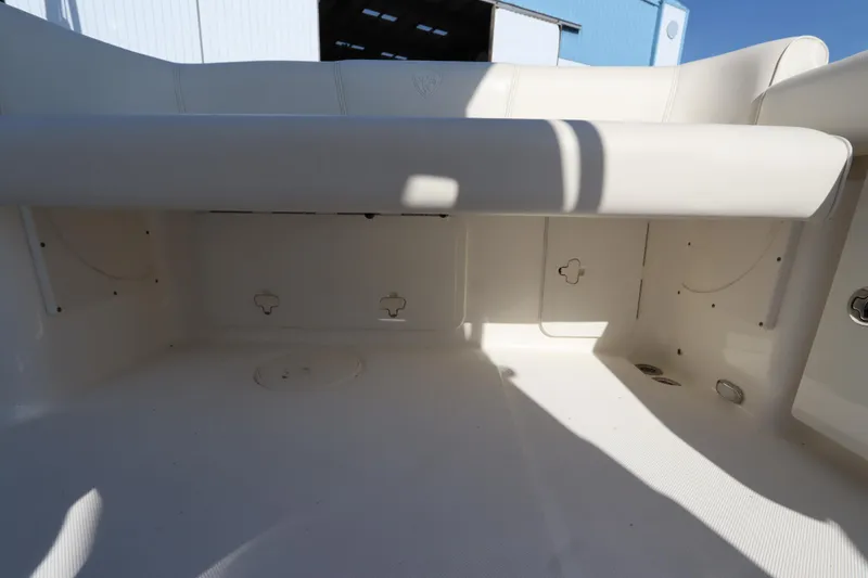 Slide: The Image of 2009 Century 2400 Walk-Around boat interior with white seating and storage compartments. - 36