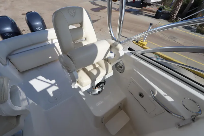 Slide: The Image of 2009 Century 2400 Walk-Around boat interior with white seating and dual Yamaha 150 engines. - 44