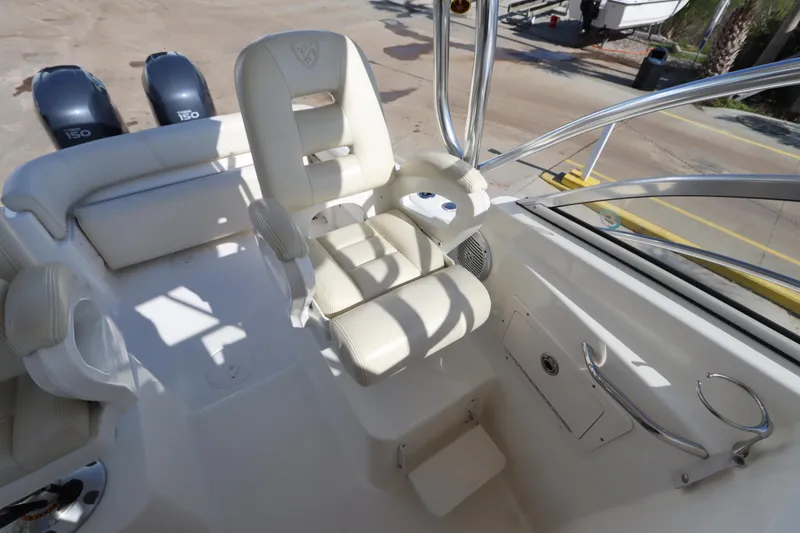 Slide: The Image of 2009 Century 2400 Walk-Around boat interior with white seating and dual engines. - 45