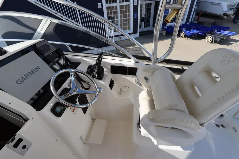 Slide: The Image of 2009 Century 2400 Walk-Around boat cockpit with Garmin navigation system and comfortable seating. - 46