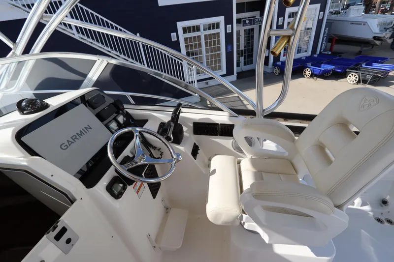 Slide: The Image of 2009 Century 2400 Walk-Around boat interior with Garmin navigation system and white seating. - 47