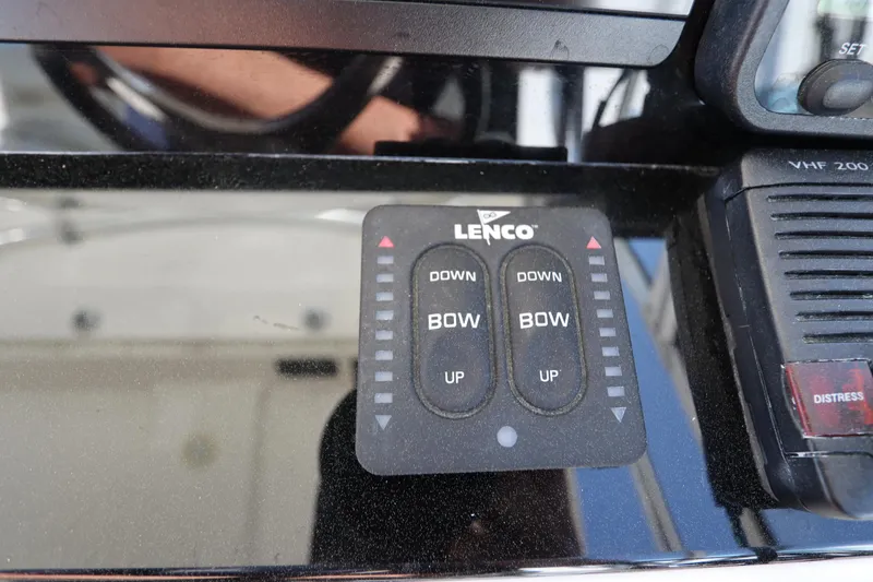 Slide: The Image of Lenco trim tab control panel on 2009 Century 2400 Walk-Around boat dashboard. - 54