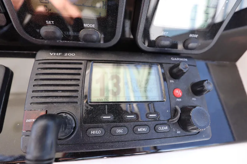 Slide: The Image of VHF 200 radio on 2009 Century 2400 Walk-Around boat dashboard. - 55