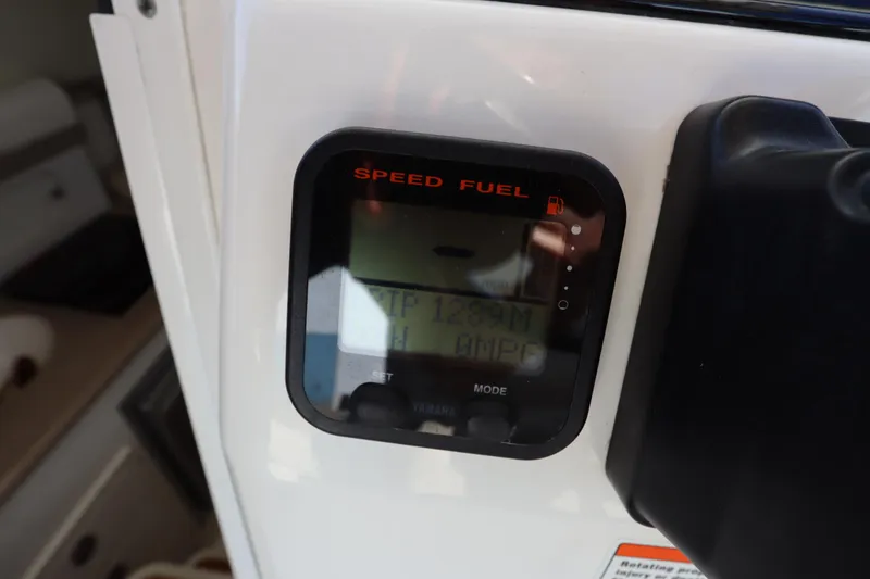 Slide: The Image of Close-up of a 2009 Century 2400 Walk-Around boat's speed and fuel gauge display. - 59