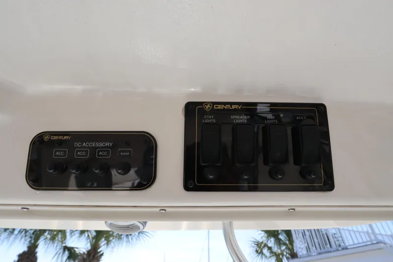 Slide: The Image of Control panel of a 2009 Century 2400 Walk-Around boat with accessory switches. - 63