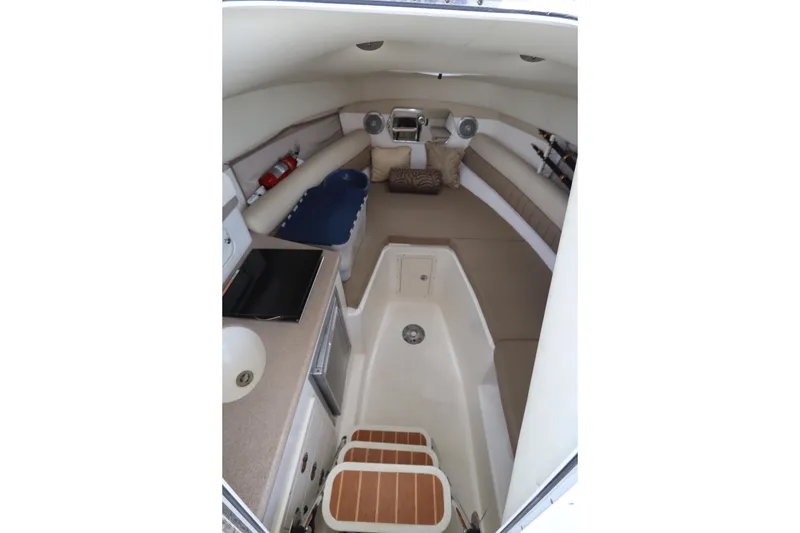 Slide: The Image of Interior of 2009 Century 2400 Walk-Around boat with seating and amenities. - 64