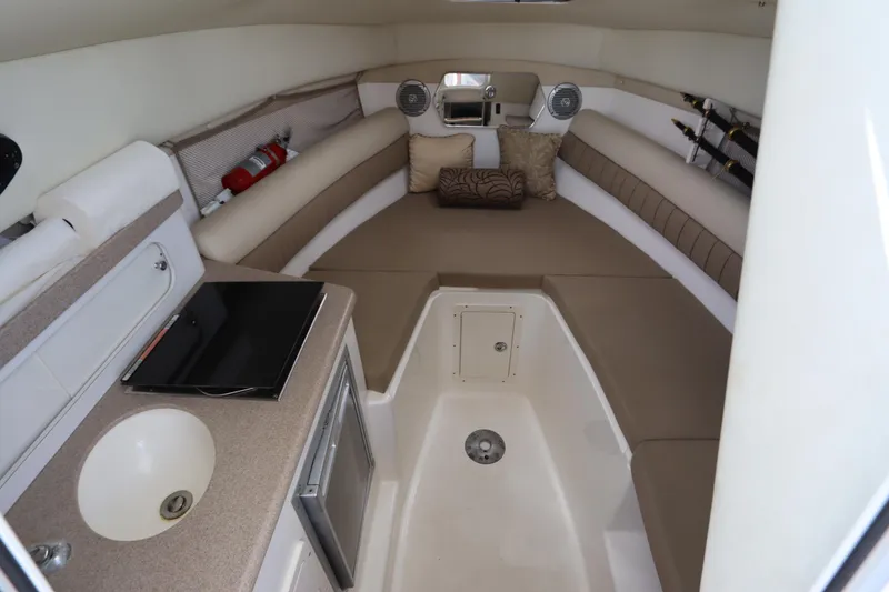 Slide: The Image of Interior of 2009 Century 2400 Walk-Around boat with seating, sink, and storage. - 65