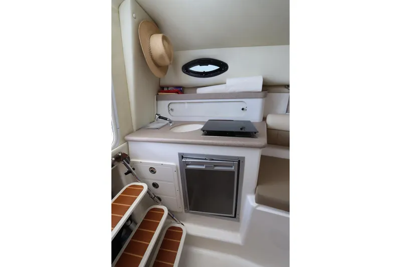 Slide: The Image of Interior of 2009 Century 2400 Walk-Around boat with kitchenette and seating area. - 69