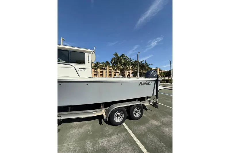Slide: The Image of 2023 Parker 2320 Sport Cabin boat on trailer in sunny parking lot. - 10
