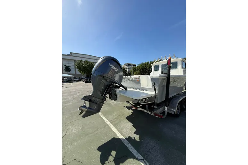 Slide: The Image of 2023 Parker 2320 Sport Cabin boat with Yamaha outboard motor on trailer. - 17