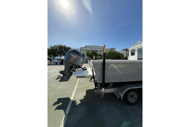 Slide: The Image of 2023 Parker 2320 Sport Cabin boat with Yamaha outboard motor on trailer. - 18