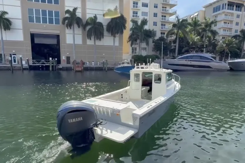 Slide: The Image of 2023 Parker 2320 Sport Cabin boat with Yamaha engine in marina setting. - 3