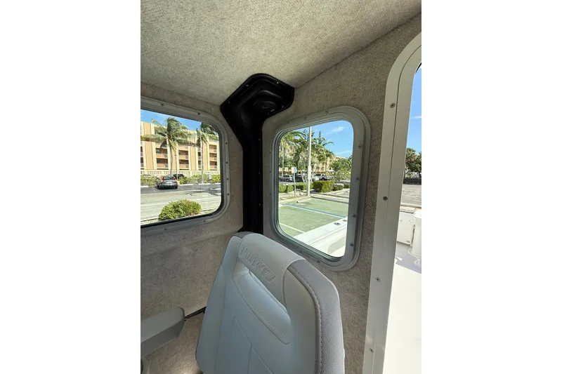 Slide: The Image of Interior view of 2023 Parker 2320 Sport Cabin with windows and seating. - 55
