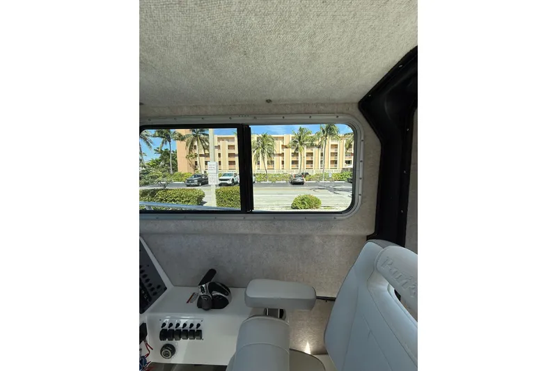 Slide: The Image of Interior view of 2023 Parker 2320 Sport Cabin boat with window and seating. - 56