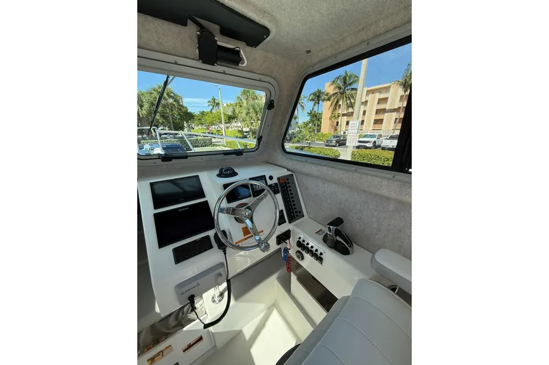 Slide: The Image of 2023 Parker 2320 Sport Cabin interior with steering wheel and control panel. - 57