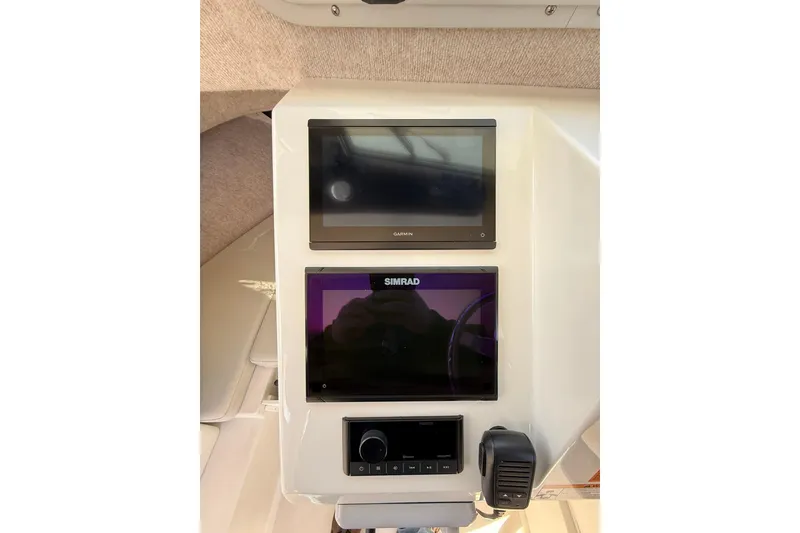 Slide: The Image of 2023 Parker 2320 Sport Cabin dashboard with Garmin and Simrad displays. - 58