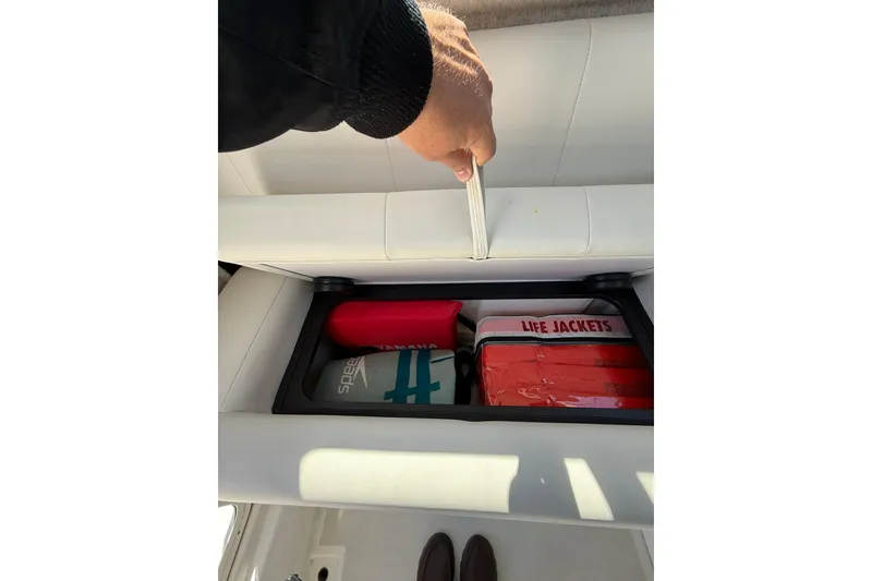 Slide: The Image of 2023 Parker 2320 Sport Cabin storage with life jackets and safety gear. - 64