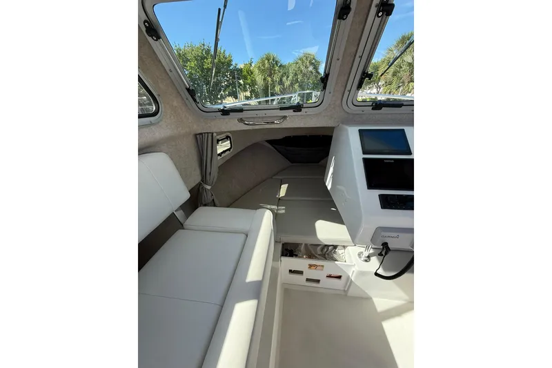 Slide: The Image of 2023 Parker 2320 Sport Cabin interior with seating and navigation equipment. - 65