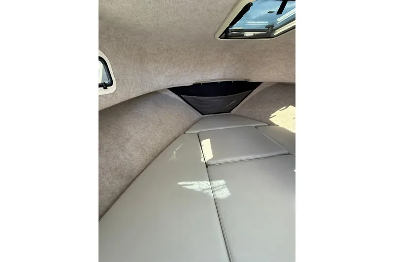 Slide: The Image of 2023 Parker 2320 Sport Cabin interior with cushioned seating and overhead window. - 66