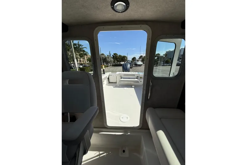 Slide: The Image of Interior view of 2023 Parker 2320 Sport Cabin boat, showing seating and open deck. - 69