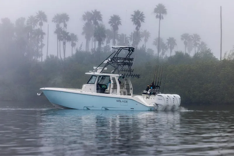 Slide: The Image of Manufacturer Provided Image: 2026 Solace 37 CS boat cruising in misty waters with palm trees in background. - 1