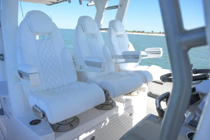 Slide: The Image of Manufacturer Provided Image: Luxury seating on 2026 Solace 37 CS boat, featuring white cushioned captain chairs. - 3