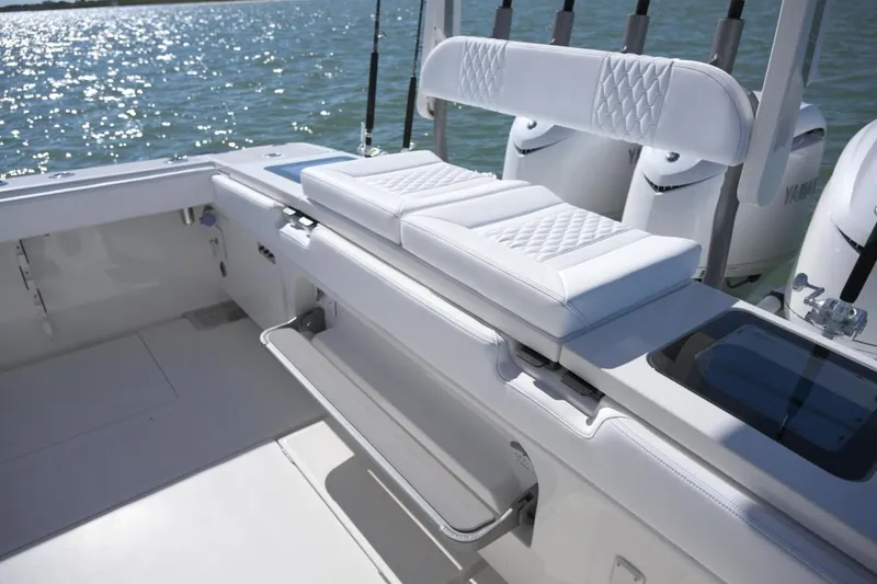 Slide: The Image of Manufacturer Provided Image: Luxurious seating on 2026 Solace 37 CS boat with quilted cushions, ocean backdrop. - 8