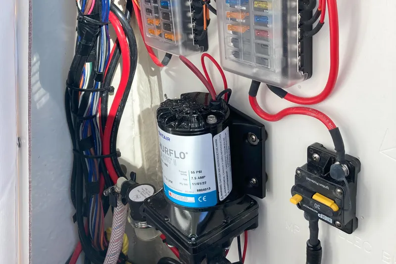 Slide: The Image of Electrical wiring and components inside a 2023 Sportsman Open 242 Center Console boat. - 24