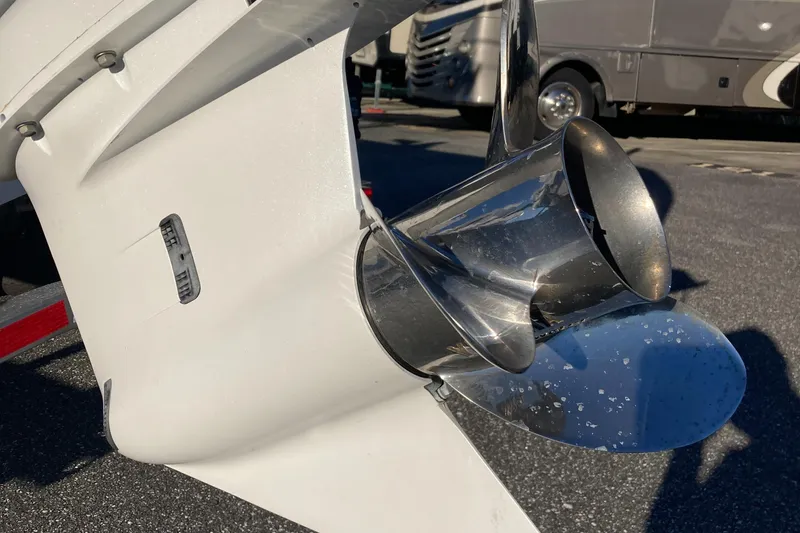 Slide: The Image of 2023 Sportsman Open 242 Center Console boat propeller in a parking lot. - 7