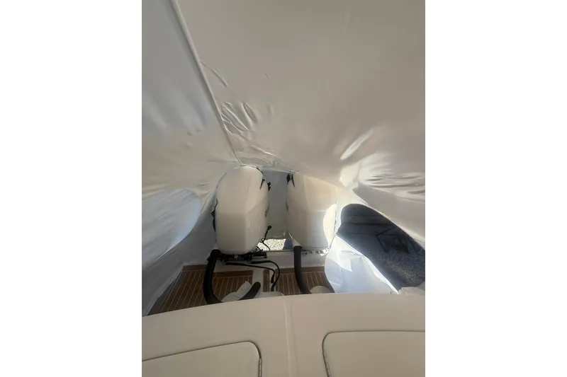 Slide: The Image of 2016 Regulator 25 boat interior with covered outboard engines. - 11
