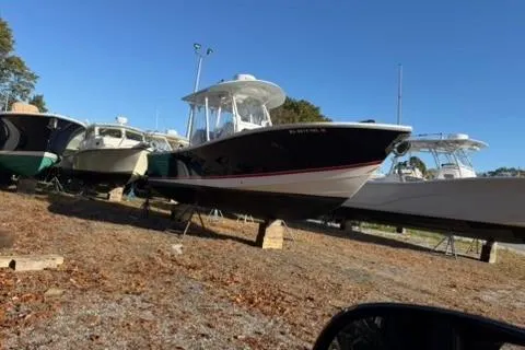 Slide: The Image of 2016 Regulator 25 boat on display in a marina under clear blue skies. - 3