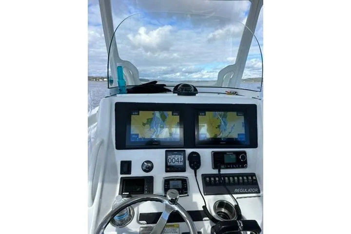 Slide: The Image of Cockpit view of 2016 Regulator 25 boat with navigation screens and controls. - 4