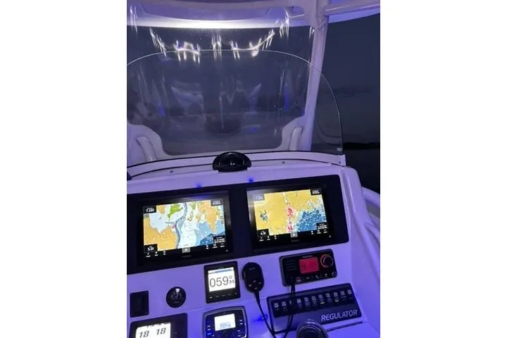 Slide: The Image of Control panel of a 2016 Regulator 25 boat with navigation screens. - 5
