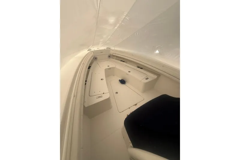Slide: The Image of 2016 Regulator 25 boat interior with seating and storage compartments. - 8
