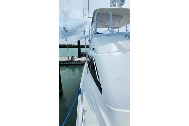 Slide: The Image of 2000 Ocean Yachts 40 Super Sport docked at marina, side view. - 11