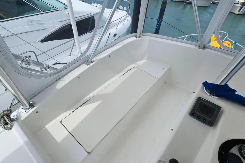 Slide: The Image of Cockpit view of a 2000 Ocean Yachts 40 Super Sport, docked with visible seating and controls. - 17