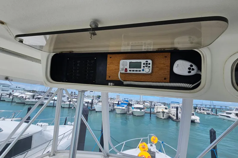 Slide: The Image of Control panel on a 2000 Ocean Yachts 40 Super Sport, overlooking a marina. - 18