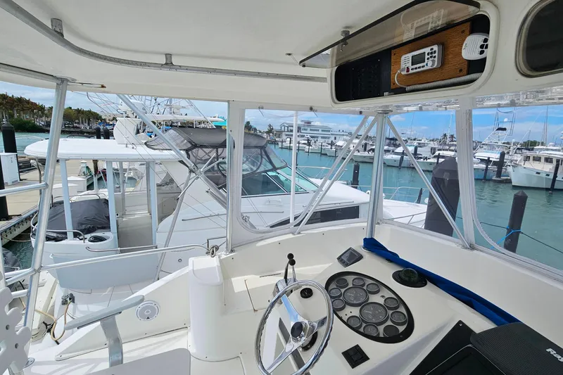 Slide: The Image of Cockpit view of 2000 Ocean Yachts 40 Super Sport at marina, showcasing helm and controls. - 29